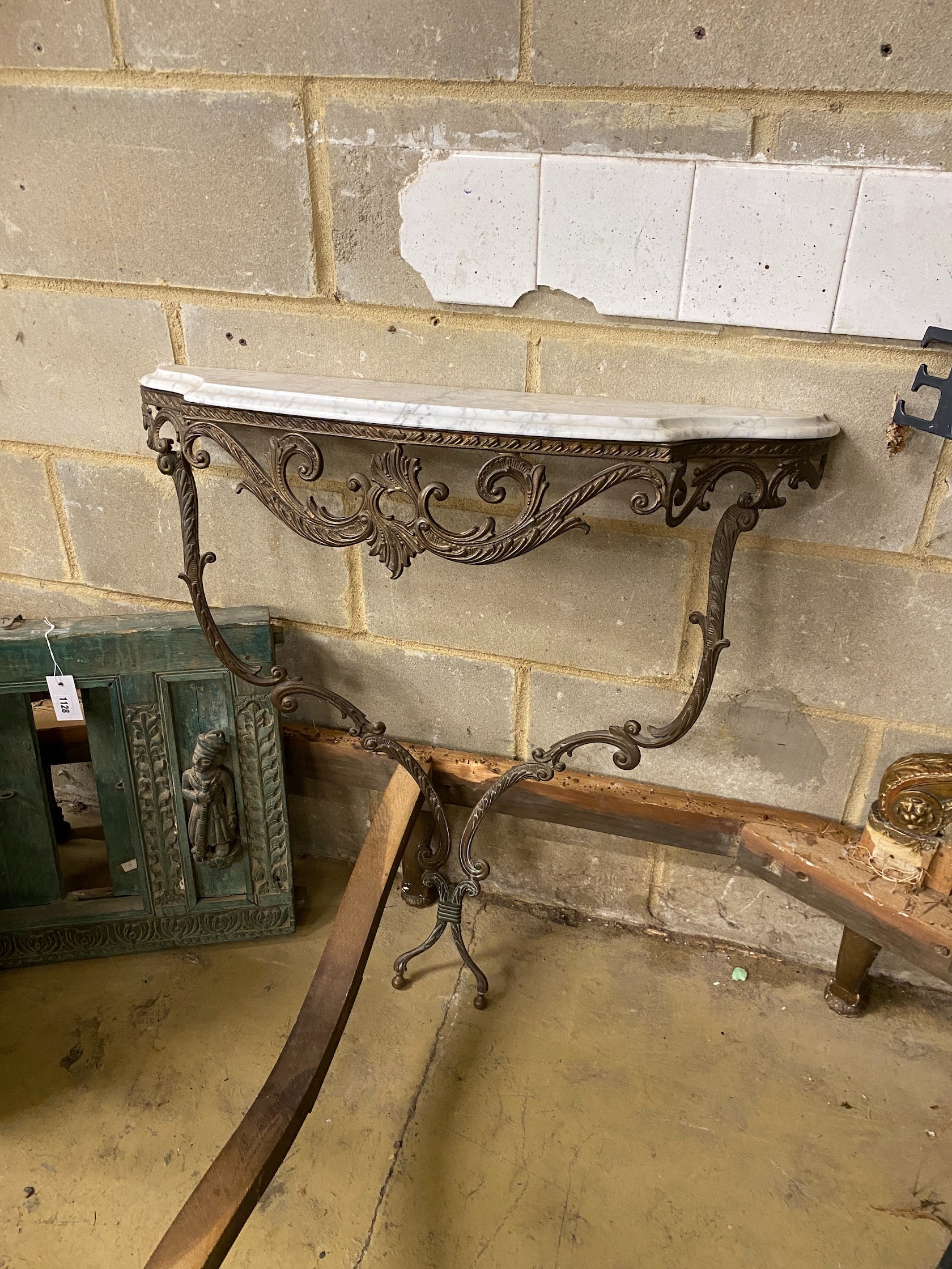 A bronzed metal and reconstituted marble console table, width 82cm, height 92cm and mirror
